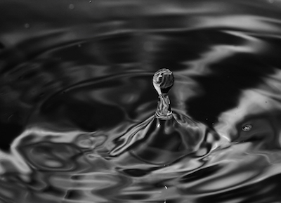 a water droplet causing ripples
